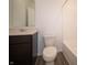 Well-lit bathroom featuring a vanity, mirror, toilet, and shower-tub combo at 7824 Magnolia St, New Palestine, IN 46163