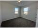 Well-lit bedroom with gray carpet and two large windows at 7824 Magnolia St, New Palestine, IN 46163