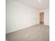 This bedroom offers a double closet, neutral carpet, and provides natural light and a view of the hallway at 7824 Magnolia St, New Palestine, IN 46163