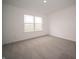Bright bedroom featuring a large window and neutral carpeting for a serene living space at 7824 Magnolia St, New Palestine, IN 46163