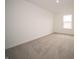 A comfortable bedroom offers neutral carpet and a window for natural light, creating a relaxing space at 7824 Magnolia St, New Palestine, IN 46163