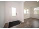 Bright foyer features wood-look flooring and a glass-paneled front door for natural light at 7824 Magnolia St, New Palestine, IN 46163