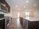 Modern kitchen with stainless steel appliances, island with sink and hard surface floors at 7824 Magnolia St, New Palestine, IN 46163