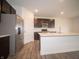 Modern kitchen featuring a stainless steel refrigerator, island, and updated cabinets at 7824 Magnolia St, New Palestine, IN 46163