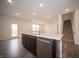 Modern kitchen with island and stainless steel dishwasher, sink, and hardwood floors at 7824 Magnolia St, New Palestine, IN 46163