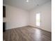 The open living space features hard surface floors and a glass paneled back door at 7824 Magnolia St, New Palestine, IN 46163