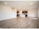 Expansive living space featuring wood-look floors, recessed lights, and modern kitchen view at 7824 Magnolia St, New Palestine, IN 46163