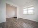 Open-concept living area with wood-look floors and large windows providing ample natural light at 7824 Magnolia St, New Palestine, IN 46163