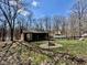 Backyard of a cabin featuring a stone firepit and surrounded by black fencing at 7887 Elk Dr, Nineveh, IN 46164