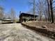 Charming cabin home with wraparound porch, two-car garage and landscaping, on a sunny day at 7887 Elk Dr, Nineveh, IN 46164