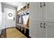 White mudroom with built-in bench, cubbies, and coat hooks at 7928 Stonebriar Way, Indianapolis, IN 46259