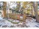 Wooden deck overlooks a partially snow-covered backyard with trees at 8022 Talliho Dr, Indianapolis, IN 46256