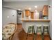 Basement kitchenette with wood cabinets and a breakfast bar at 8022 Talliho Dr, Indianapolis, IN 46256
