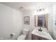 Small bathroom with white toilet and sink, wood vanity, and shiplap walls at 8022 Talliho Dr, Indianapolis, IN 46256
