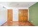 Spacious bedroom with wood flooring and double doors leading to closets at 8022 Talliho Dr, Indianapolis, IN 46256