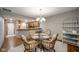 Dining area with a glass-top table and four chairs, near kitchen at 8022 Talliho Dr, Indianapolis, IN 46256
