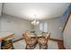 Dining area with a glass-top table and four chairs, near kitchen at 8022 Talliho Dr, Indianapolis, IN 46256