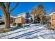 Brick and gray-sided home with a two-car garage and snow-covered landscaping at 8022 Talliho Dr, Indianapolis, IN 46256