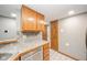 Kitchen with oak cabinets, stainless steel appliances, and gray walls at 8022 Talliho Dr, Indianapolis, IN 46256