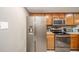 Kitchen with stainless steel appliances and oak cabinets at 8022 Talliho Dr, Indianapolis, IN 46256