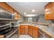 Kitchen with stainless steel appliances, oak cabinets, and a breakfast bar at 8022 Talliho Dr, Indianapolis, IN 46256
