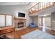 Open living room with high ceilings, fireplace, and loft view at 8022 Talliho Dr, Indianapolis, IN 46256