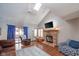 Spacious living room features a brick fireplace, vaulted ceiling, and hardwood floors at 8022 Talliho Dr, Indianapolis, IN 46256