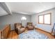 Cozy loft area with two armchairs, hardwood floors, and a window at 8022 Talliho Dr, Indianapolis, IN 46256