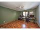 Home office with hardwood floors, two desks, and large windows at 8022 Talliho Dr, Indianapolis, IN 46256