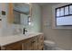 Updated bathroom with light vanity and bathtub at 814 N Audubon Rd, Indianapolis, IN 46219