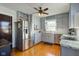 Modern kitchen with stainless steel appliances and light gray cabinets at 814 N Audubon Rd, Indianapolis, IN 46219