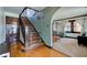 Hardwood staircase with a wooden railing and a view of the living room at 814 N Audubon Rd, Indianapolis, IN 46219