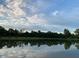 Peaceful backyard pond reflecting a stunning cloudy sky at 8152 Cottonwood Dr, Martinsville, IN 46151