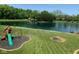 Spacious backyard with a pond, playground, and manicured lawn at 8152 Cottonwood Dr, Martinsville, IN 46151