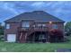 Brick home with deck, stairs, and a playground in the backyard at 8152 Cottonwood Dr, Martinsville, IN 46151