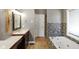 Bathroom with double vanity, jetted tub, and tile surround at 8152 Cottonwood Dr, Martinsville, IN 46151