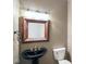 Small bathroom with pedestal sink and rustic mirror at 8152 Cottonwood Dr, Martinsville, IN 46151