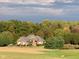 Brick home nestled in a wooded area with a pond in the distance at 8152 Cottonwood Dr, Martinsville, IN 46151