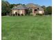 Brick home with a large green lawn and mature trees in the background at 8152 Cottonwood Dr, Martinsville, IN 46151
