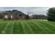 Brick home with neatly striped lawn, and a pond view at 8152 Cottonwood Dr, Martinsville, IN 46151