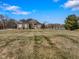 Brick house with large yard, attached garage, and pond view at 8152 Cottonwood Dr, Martinsville, IN 46151