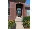 Brick front entrance with arched entryway and mature landscaping at 8152 Cottonwood Dr, Martinsville, IN 46151