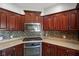 Kitchen corner with gas cooktop, microwave, and dark wood cabinets at 8152 Cottonwood Dr, Martinsville, IN 46151