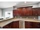Modern kitchen with corner sink, dark wood cabinets and tile backsplash at 8152 Cottonwood Dr, Martinsville, IN 46151