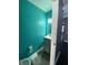 Small teal bathroom with a vanity and toilet at 8531 Friendship Ln, Indianapolis, IN 46217