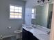 Bathroom with double vanity, large mirror, and window at 8531 Friendship Ln, Indianapolis, IN 46217