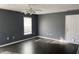 Bedroom with dark gray walls, hardwood floors and ceiling fan at 8531 Friendship Ln, Indianapolis, IN 46217