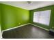 Bedroom with lime green walls and dark hardwood floors at 8531 Friendship Ln, Indianapolis, IN 46217