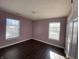 Bedroom with purple walls and dark hardwood floors at 8531 Friendship Ln, Indianapolis, IN 46217