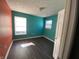 Bedroom with teal and orange walls and dark hardwood floors at 8531 Friendship Ln, Indianapolis, IN 46217